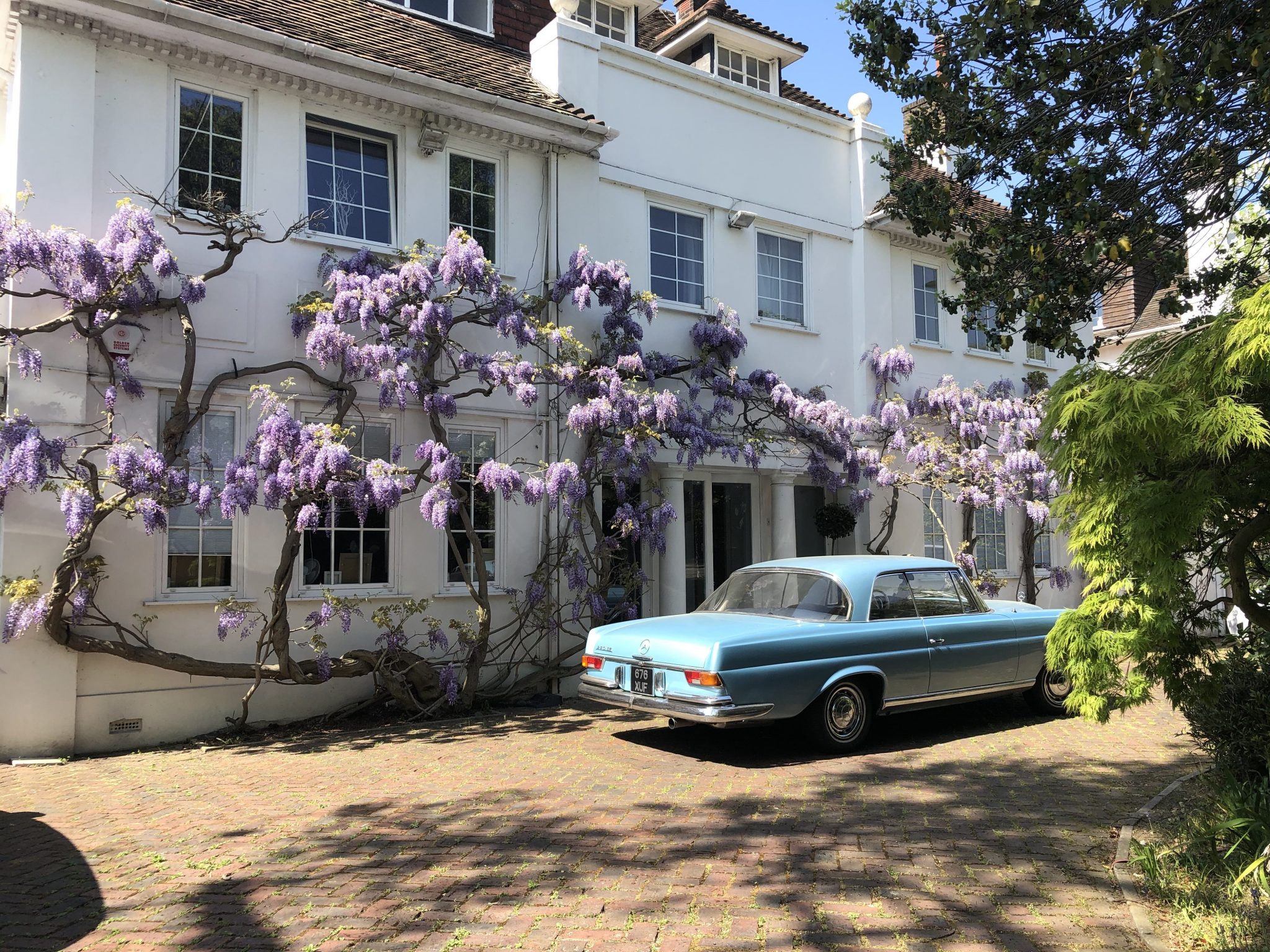Classic car wisteria flowers brick driveway TV filming location hire lodge London 1