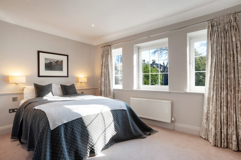 Bedroom double bed modern classic neutral carpet windows TV filming location hire lodge London 80