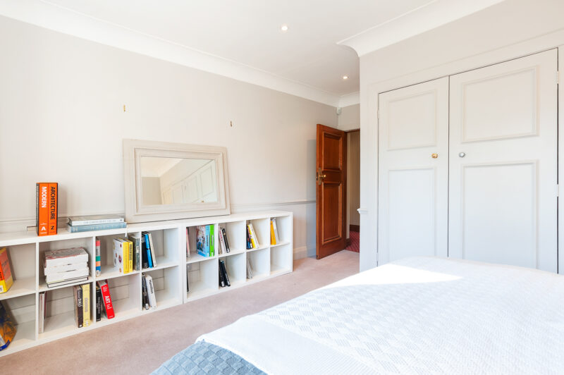 Bedroom double bed neutral modern classic bookshelves art books TV filming location hire lodge London 81