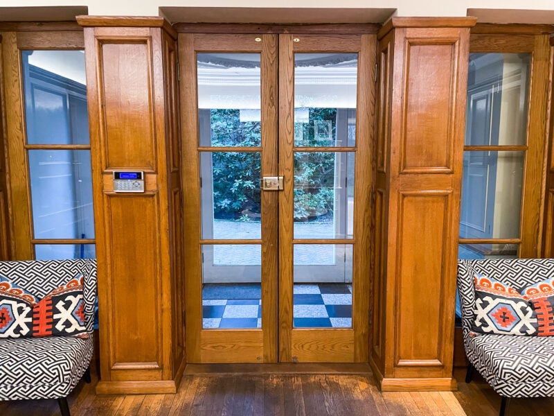 Entrance hall oak panelling 1930s large glass doors filming location hire lodge London 45