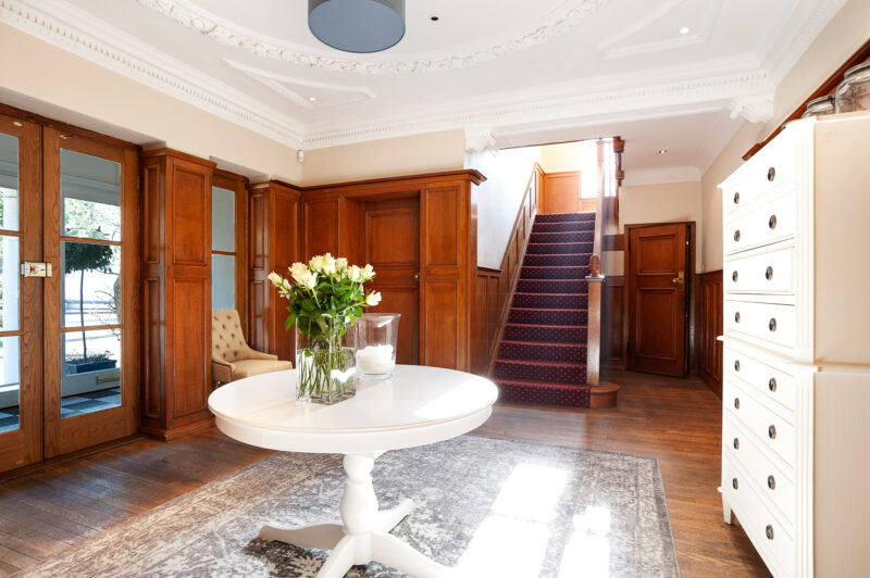Luxury Entrance hall white table chest 1930s large staircase TV filming location hire lodge London 39