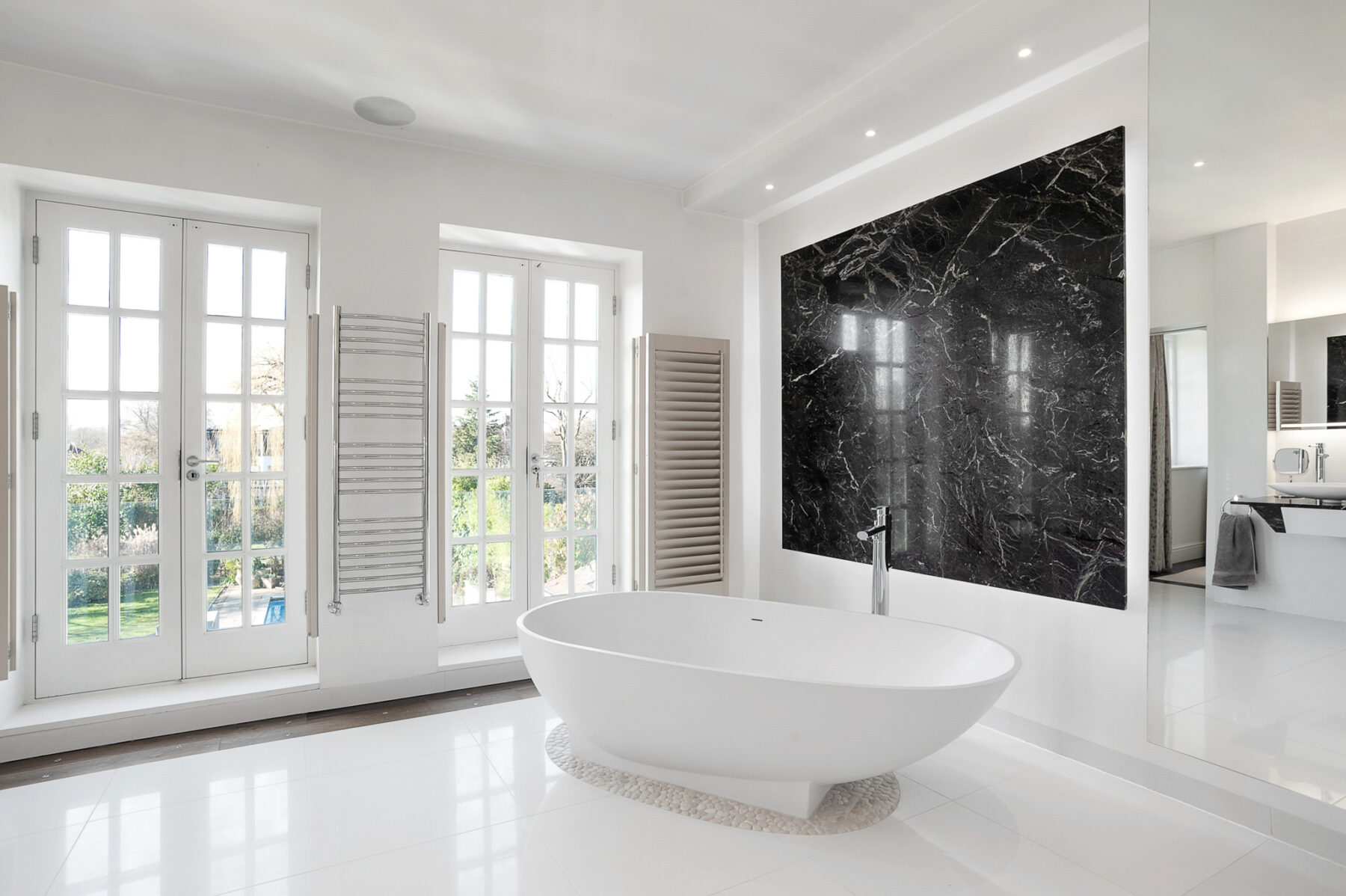 Bathroom modern white marble shutters bath garden view TV filming location hire lodge London 72