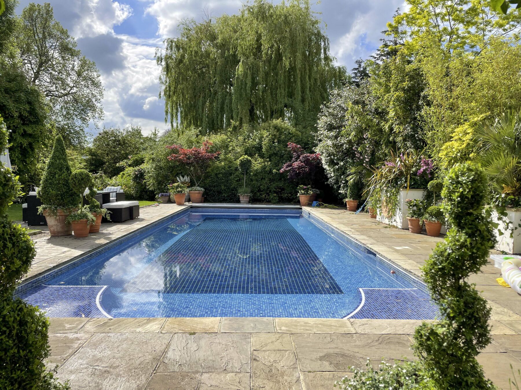 Garden plants manicured mosaic swimming pool trees furniture TV filming location hire lodge London 17