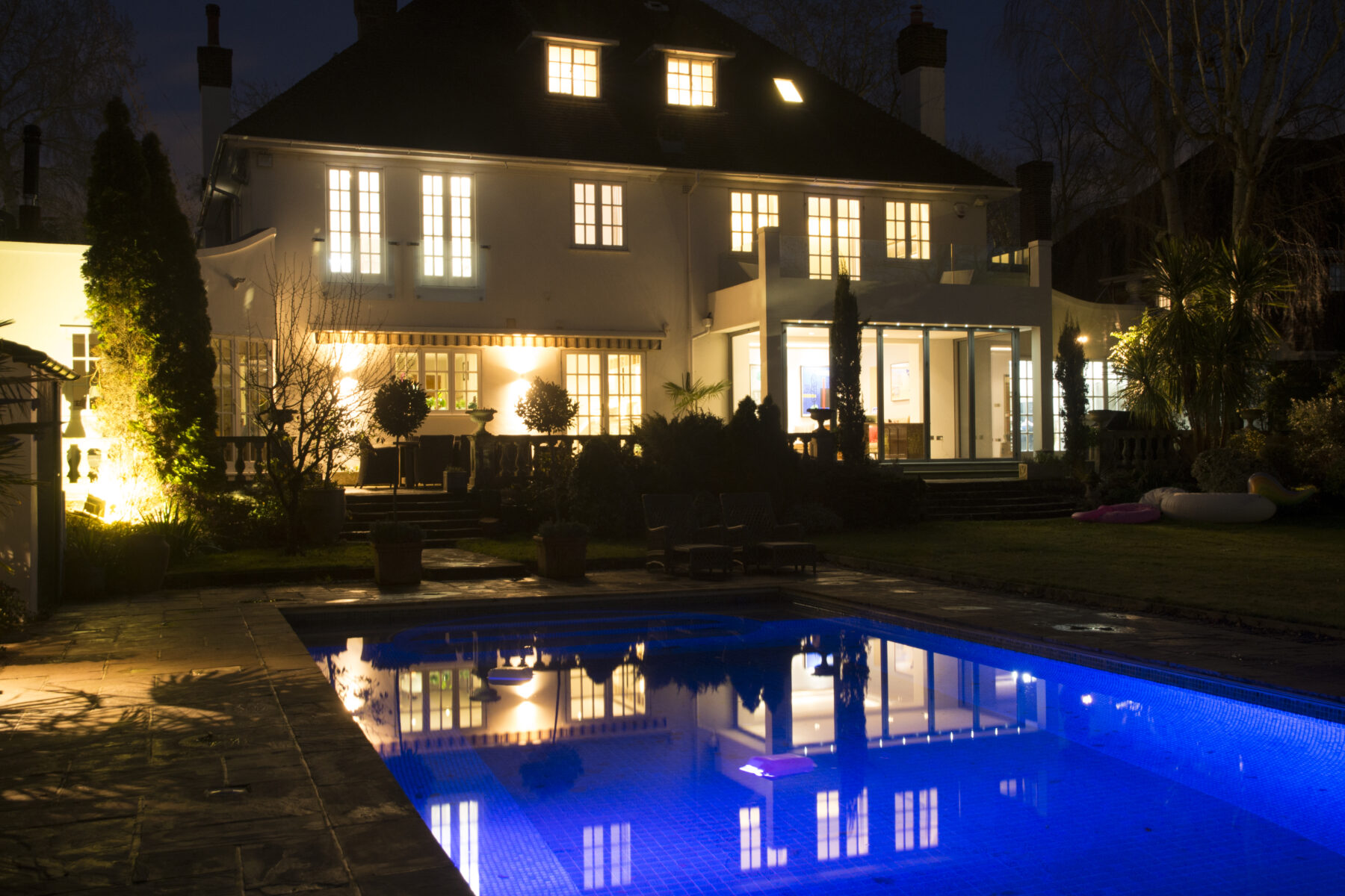 Garden white house nighttime trees 1930s lighting swimming pool lights TV filming location hire lodge London 17