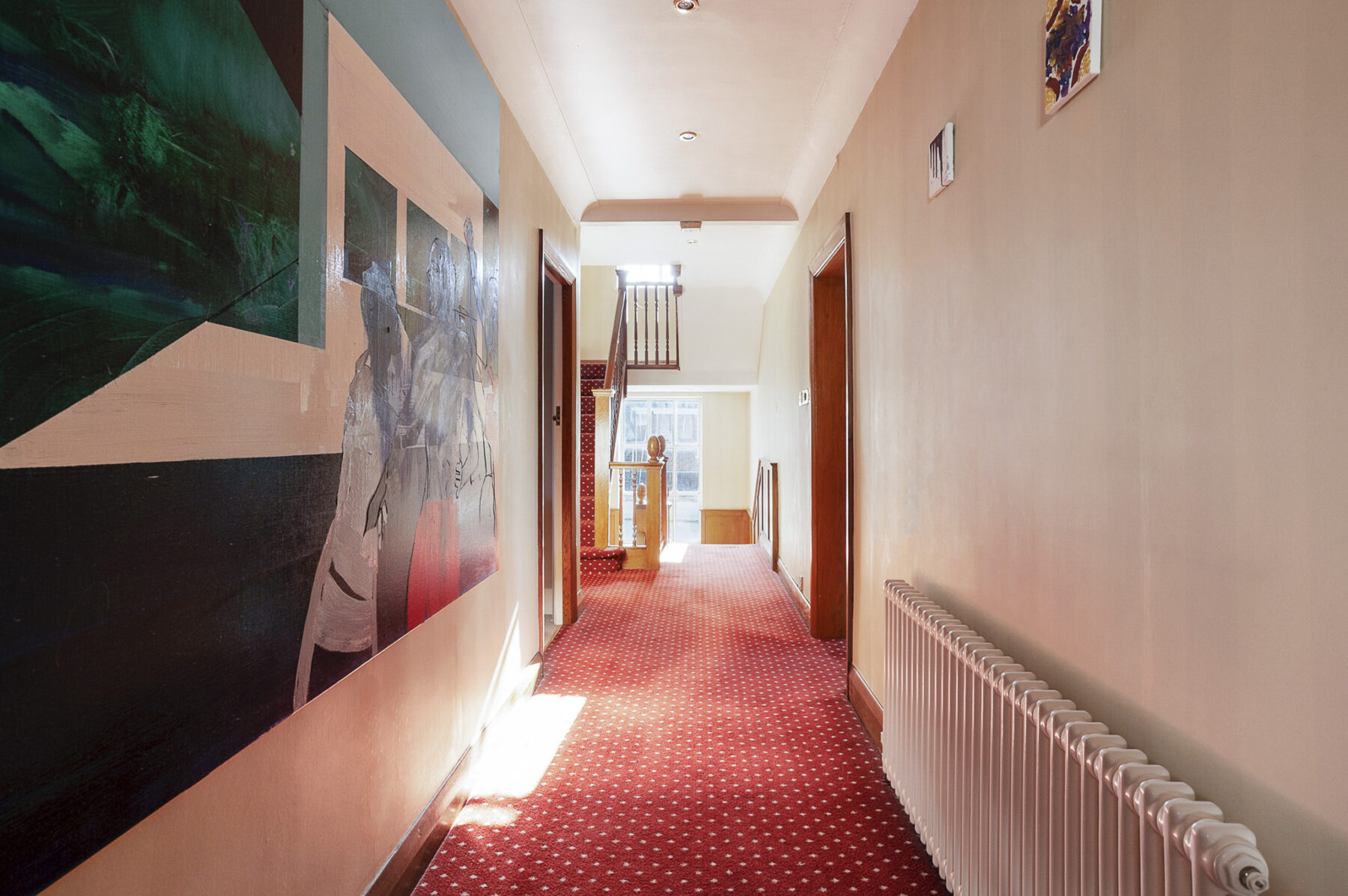 Long hallway carpet pale walls doorways painting sunlight TV filming location hire lodge London 41